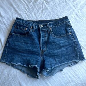 Dark wash denim Levi’s 501 shorts.